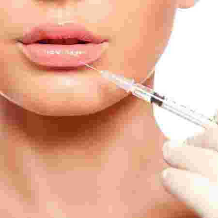 Reach Clinic Banner - Woman receiving lip filler injection